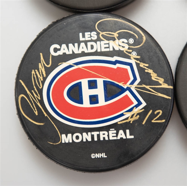 Lot of (4) Signed Montreal Canadiens Hockey Pucks (Guy Lafleur, Gump Worsley, Yvan Cournoyer, Elmer Lach)  - JSA Auction Letter