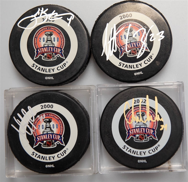 Lot of (4) Signed 2000 Stanley Cup Hockey Pucks (Chris Chelios, Martin Brodeur, Scott Stevens, Scott Gomez)  - JSA Auction Letter