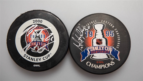 Martin Brodeur (1995 Stanley Cup) and Patrik Elias (2000 Stanley Cup) Signed Hockey Pucks  - JSA Auction Letter