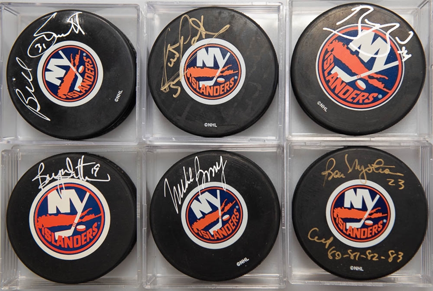 Lot of (6) Signed New York Islanders Hockey Pucks (Denis Potvin, Mike Bossy, Bryan Trottier, Bob Nystrom, Billy Smith, Bryan Berard)  - JSA Auction Letter