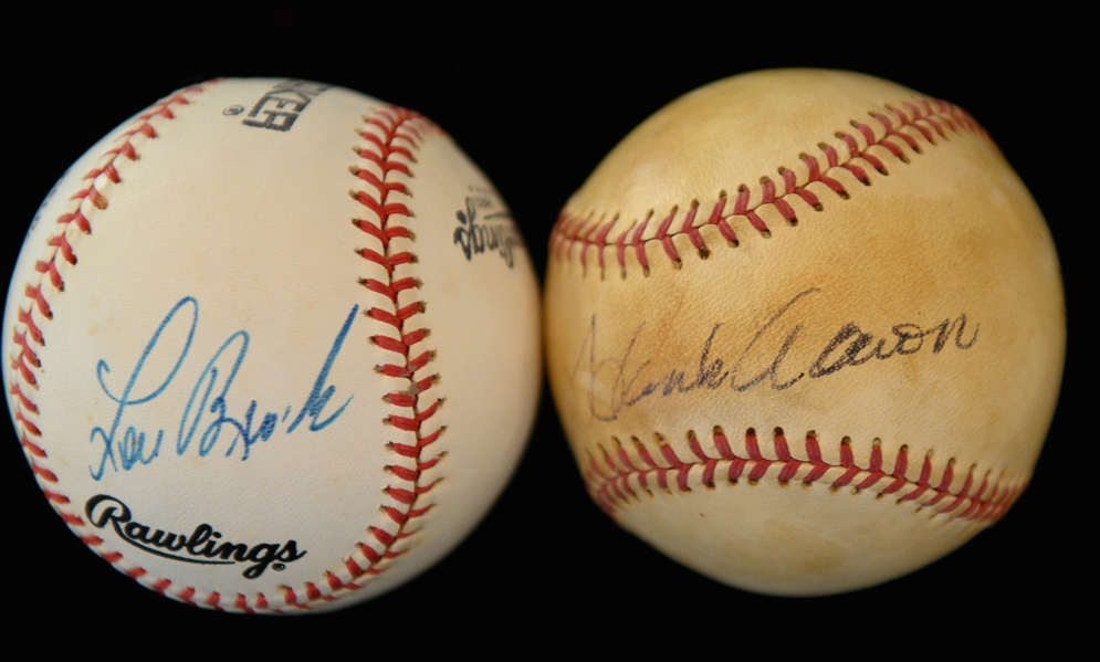 Hank Aaron & Lou Brock Signed Baseballs - JSA Auction LOA