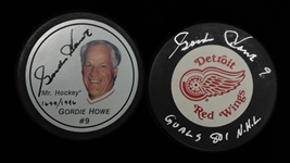 Lot of (2) Autographed Gordie Howe Hockey Pucks (JSA Auction Letter)