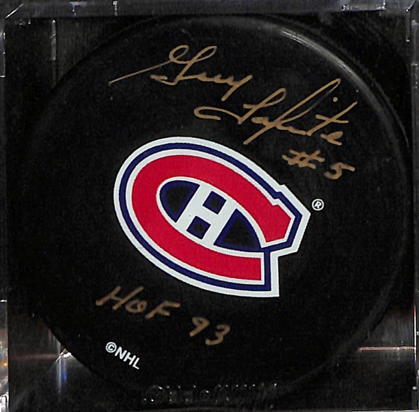 Lot of (4)  Signed Hockey Pucks- Denis Savard (HOF), Boom Boom Bernie Geoffrion (HOF), Guy Lapointe (HOF), Mike Eruzione (JSA COA) - JSA Auction Letter