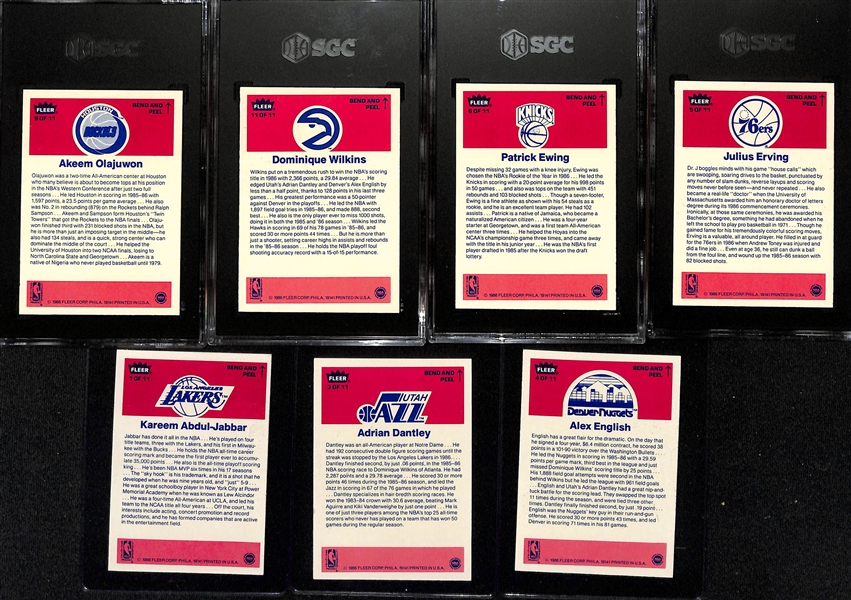 1986-87 Fleer Basketball Partial Sticker Set (7 of 11 stickers) inc. 4 Graded (Julius Erving SGC 8.5, Patrick Ewing SGC 7.5, Dominique Wilkins SGC 8.5, Akeem Olajuwon SGC 8.5) - Missing Michael...