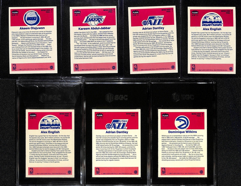 (7) 1986-87 Fleer Basketball Stickers inc. Olajuwon, Abdul-Jabbar & 3 Graded (Alex English SGC 8.5, Adrian Dantley SGC 8, Dominique Wilkins SGC 8.5) - Inc. Duplicates of Dantley & English.