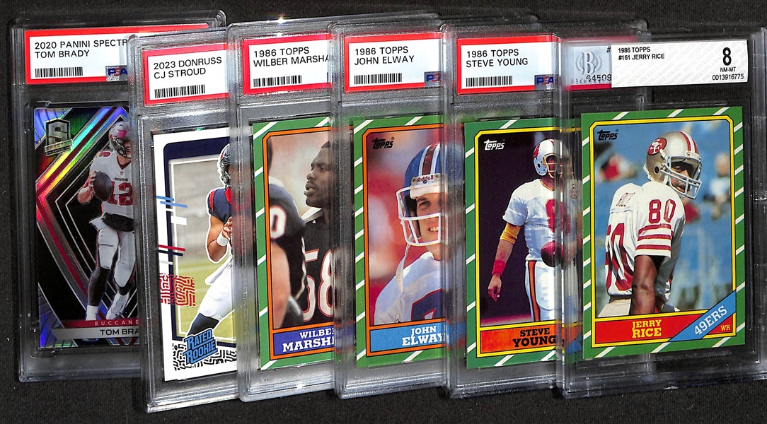 (6) Graded Football Cards w. 1986 Topps Jerry Rice Rookie (BGS 8), Steve Young (PSA 7), John Elway (PSA 8), Wilbur Marshall (PSA 8).  Also Includes 2023 Donruss CJ Stroud (PSA 9) & 2020 Spectra Tom...